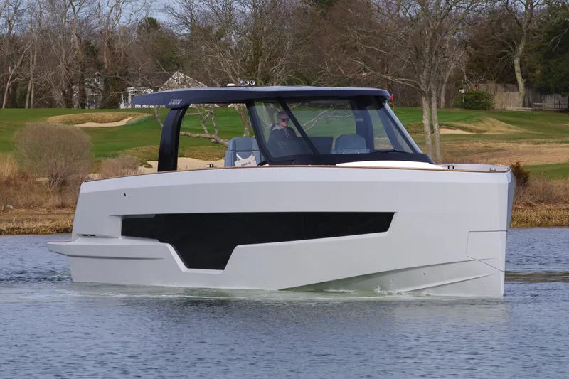 The Image of 2025 Fjord 41 XP yacht cruising on a calm lake with scenic background. - 0