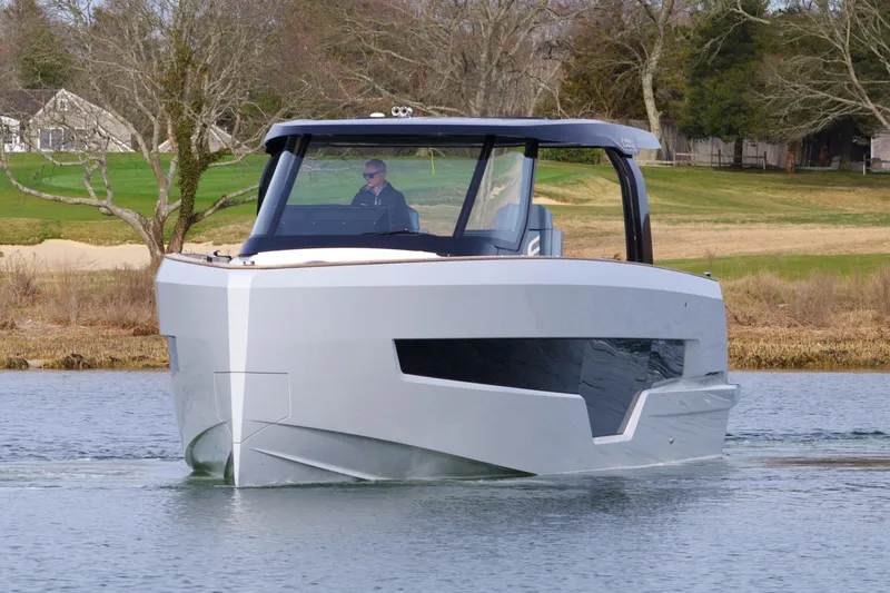 Slide: The Image of 2025 Fjord 41 XP boat cruising on a calm lake with modern design. - 13