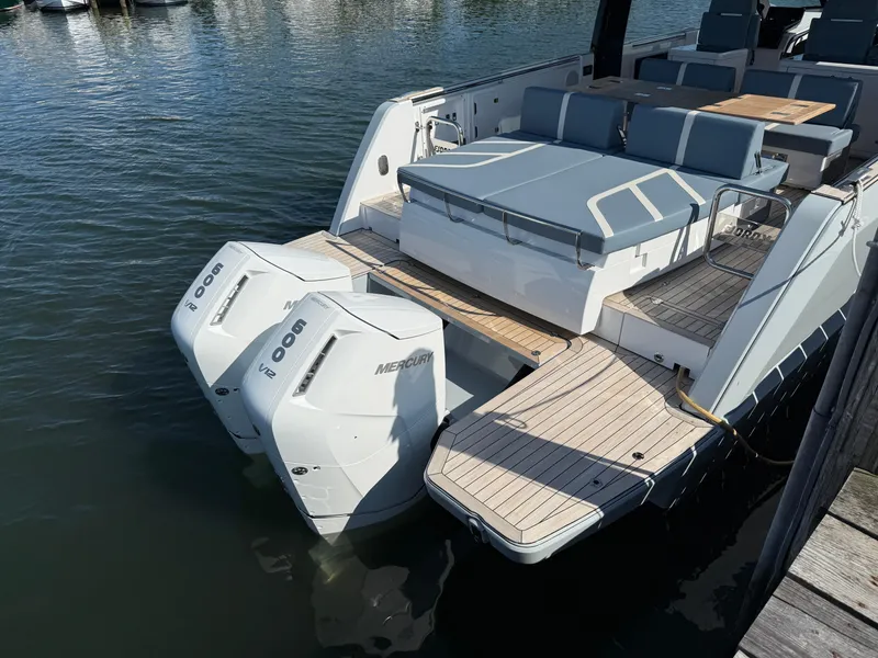 Slide: The Image of 2025 Fjord 41 XP yacht with twin outboard engines, docked in a marina. - 17