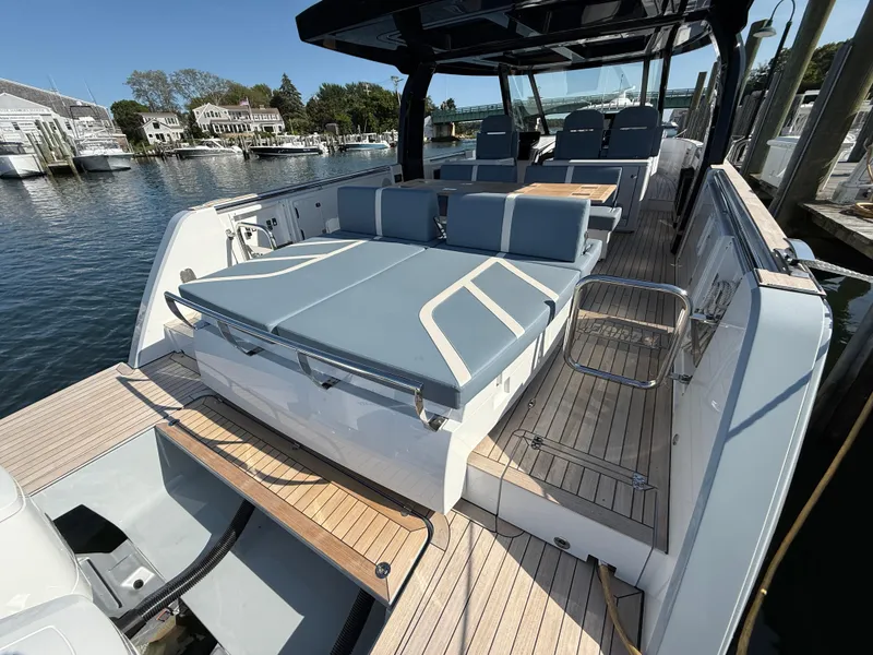 Slide: The Image of 2025 Fjord 41 XP luxury yacht with spacious deck and modern seating, docked at marina. - 20