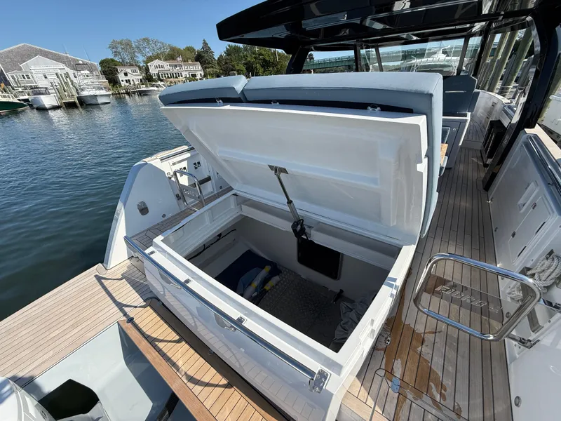 Slide: The Image of 2025 Fjord 41 XP yacht with open storage compartment, docked by the water. - 25