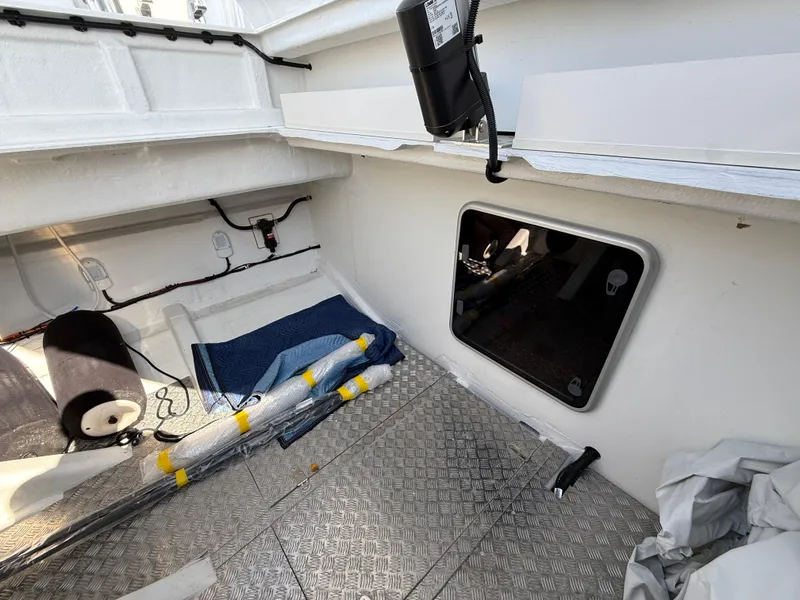 Slide: The Image of Interior view of 2025 Fjord 41 XP boat, featuring storage area and equipment. - 28