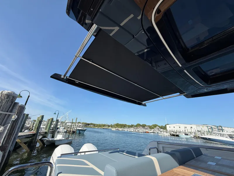 Slide: The Image of 2025 Fjord 41 XP yacht with retractable awning at a marina. - 33
