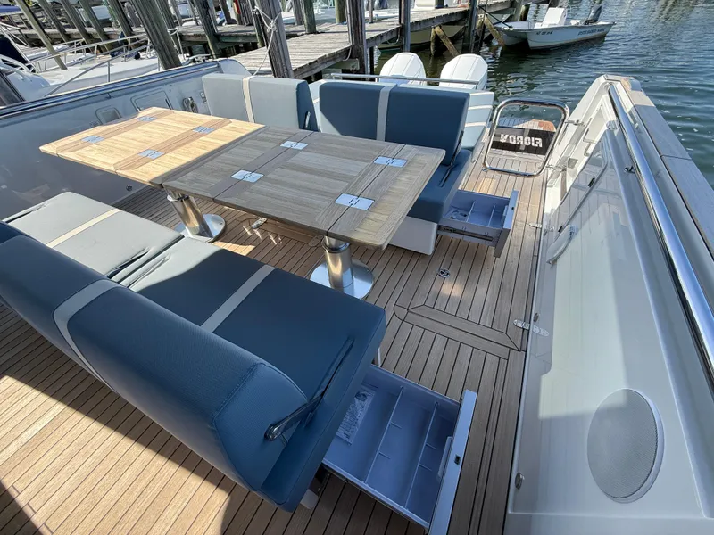 Slide: The Image of Luxury seating area on 2025 Fjord 41 XP yacht with wooden table and storage. - 38