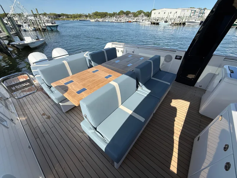 Slide: The Image of Luxurious 2025 Fjord 41 XP yacht with spacious seating and elegant wooden table on deck. - 40