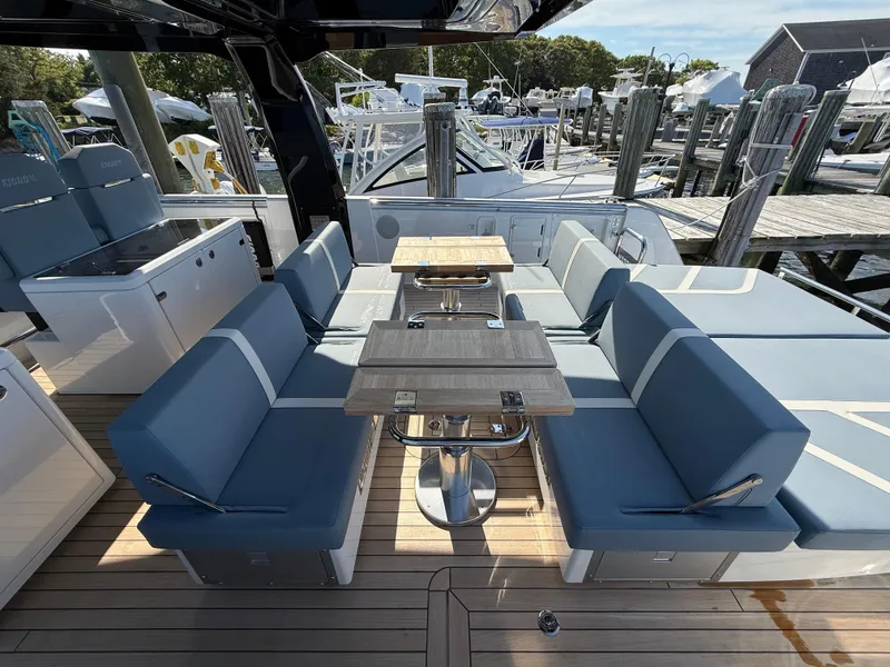 Slide: The Image of Luxurious 2025 Fjord 41 XP yacht with elegant seating and dining area on deck. - 44