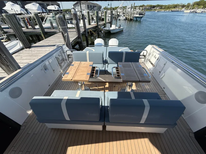 Slide: The Image of 2025 Fjord 41 XP yacht with elegant seating and dining area at a marina. - 45