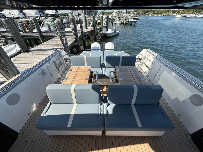 Slide: The Image of Luxurious 2025 Fjord 41 XP yacht interior with elegant seating and wooden tables at a marina. - 46