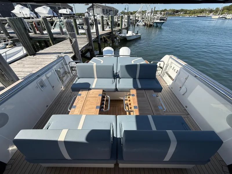 Slide: The Image of Luxurious 2025 Fjord 41 XP yacht interior with elegant seating and wooden tables at a marina. - 47