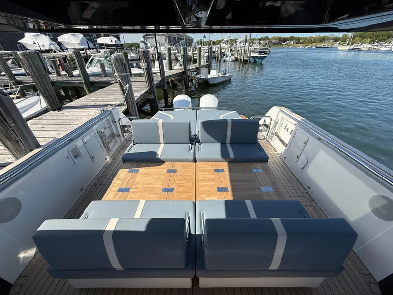 Slide: The Image of 2025 Fjord 41 XP yacht interior with blue seating, docked at marina. - 48