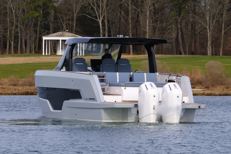 Slide: The Image of 2025 Fjord 41 XP boat on a serene lake with a scenic backdrop. - 7