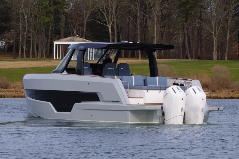 Slide: The Image of 2025 Fjord 41 XP boat on a calm lake with wooded background. - 8