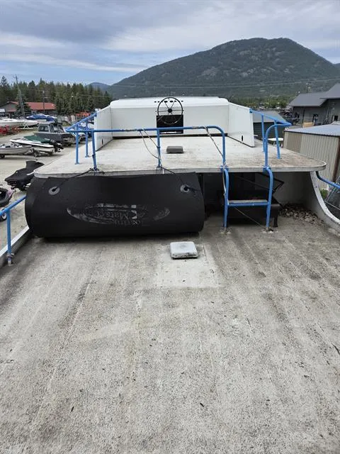 Slide: The Image of 1984 King's Craft Coastal Cruiser boat with mountain backdrop, docked in a marina. - 10
