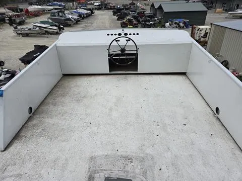 Slide: The Image of 1984 King's Craft Coastal Cruiser boat deck with steering wheel, docked in a marina. - 11