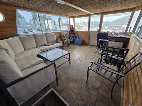 Slide: The Image of Interior of 1984 King's Craft Coastal Cruiser with seating and helm, featuring large windows. - 17