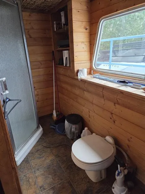 Slide: The Image of Wood-paneled bathroom in 1984 King's Craft Coastal Cruiser with shower and toilet. - 19