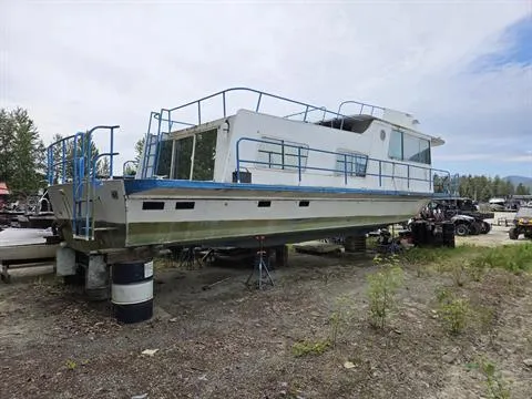 Slide: The Image of 1984 King's Craft Coastal Cruiser boat on land, with blue railings and white exterior. - 5