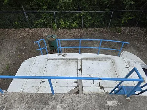 Slide: The Image of 1984 King's Craft Coastal Cruiser deck with blue railings, viewed from above. - 9