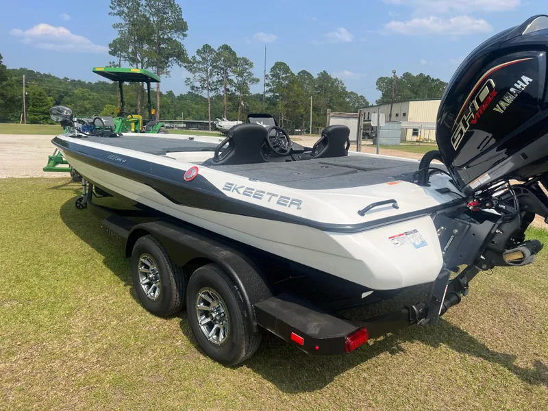 Slide: The Image of 2025 Skeeter ZXR 21 boat with Yamaha engine on a trailer, parked on grass. - 3