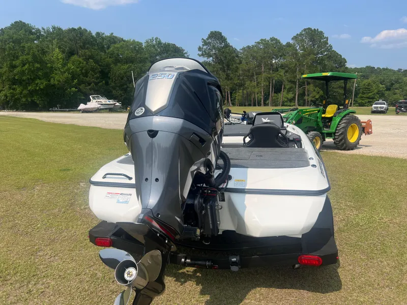 Slide: The Image of 2025 Skeeter ZXR 21 boat with powerful outboard motor on grassy area. - 4