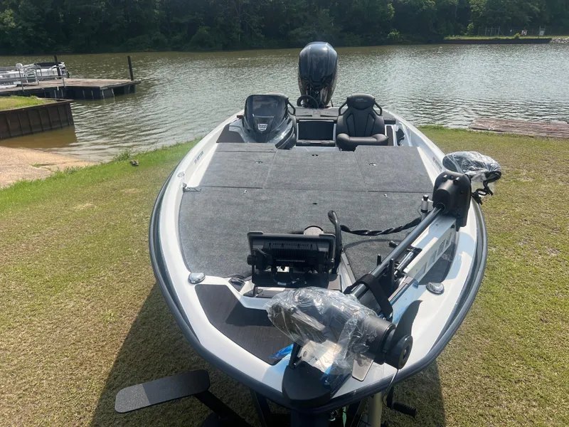 Slide: The Image of 2025 Skeeter ZXR 21 fishing boat on grassy shore by a lake. - 6