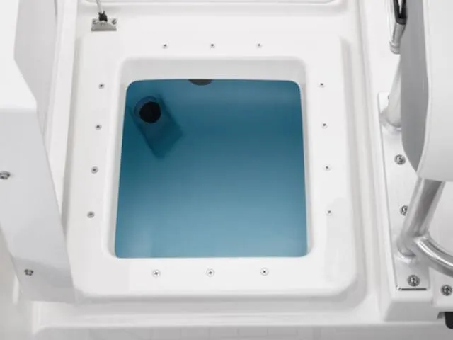 Slide: The Image of 2025 Yamaha Boats 195 FSH Sport livewell, featuring a clean, white design with blue interior. - 8