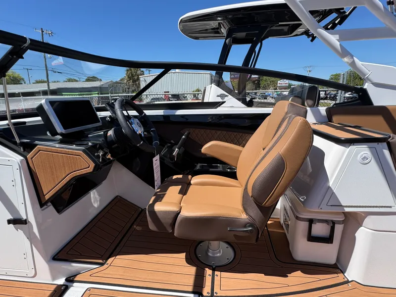 Slide: The Image of 2025 Yamaha Boats 252S cockpit with tan seating and modern dashboard. - 15