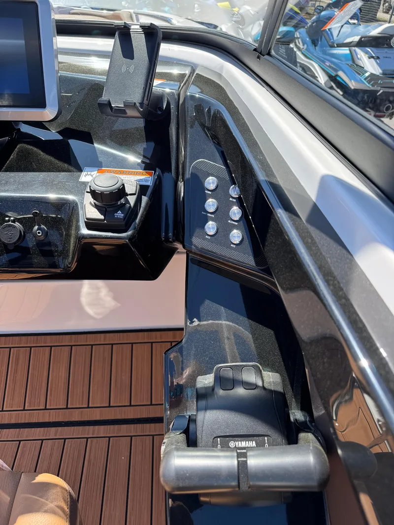 Slide: The Image of 2025 Yamaha Boats 252S dashboard with controls and display, featuring sleek design and modern technology. - 18
