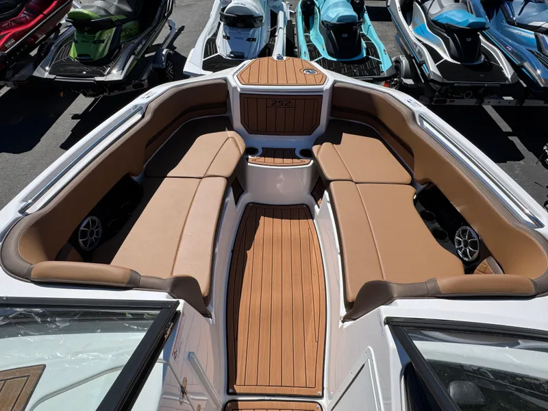 Slide: The Image of 2025 Yamaha Boats 252S interior with tan seating and wood accents. - 22
