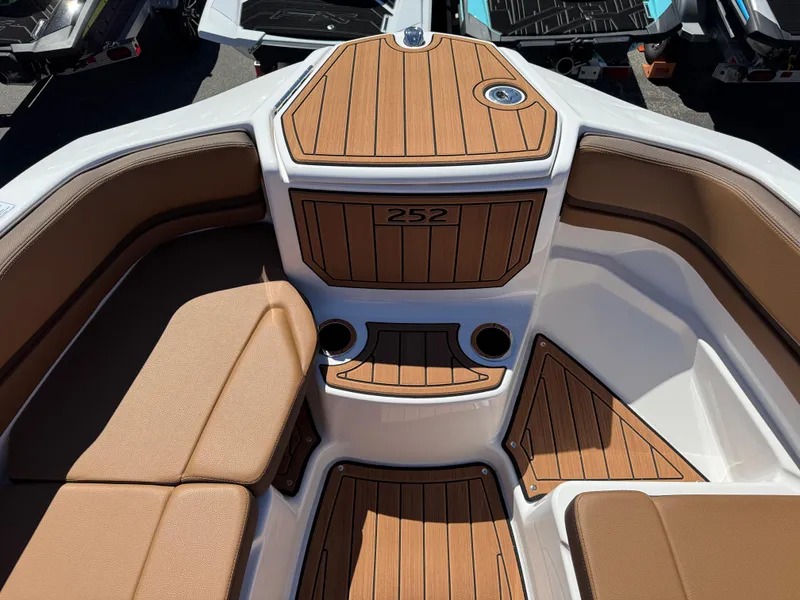 Slide: The Image of 2025 Yamaha Boats 252S interior with teak flooring and cushioned seating. - 25