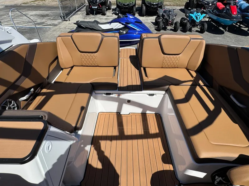 Slide: The Image of 2025 Yamaha Boats 252S interior with tan seating and wood-style flooring. - 33