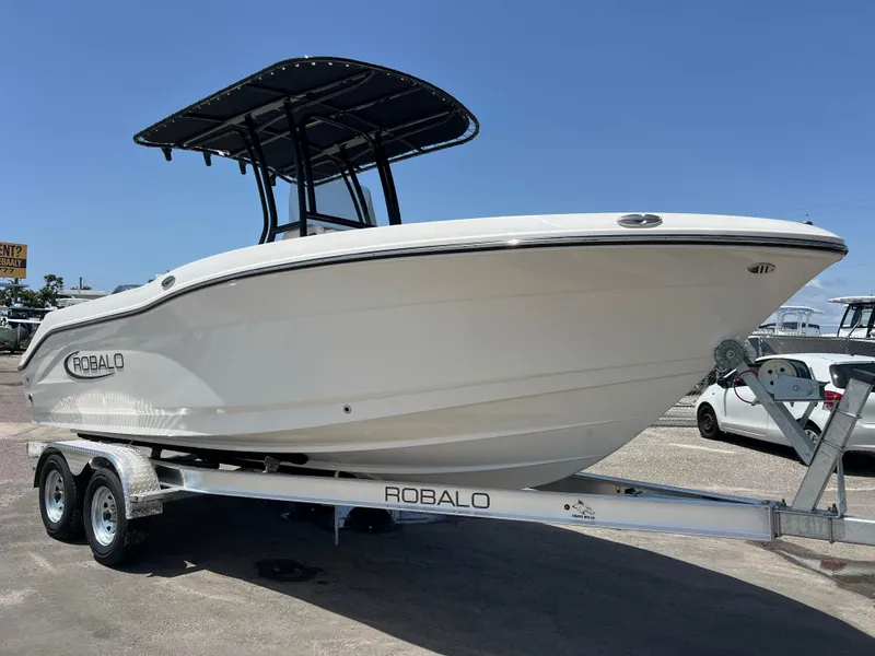 The Image of 2025 Robalo R200 Center Console boat on trailer, side view, sunny day. - 0