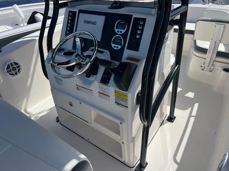 Slide: The Image of 2025 Robalo R200 Center Console boat dashboard with steering wheel and controls. - 10