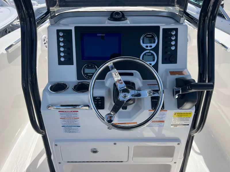 Slide: The Image of 2025 Robalo R200 Center Console dashboard with steering wheel and navigation controls. - 11