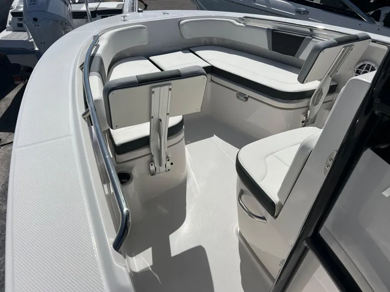 Slide: The Image of 2025 Robalo R200 Center Console boat interior with white seating and stainless steel accents. - 13
