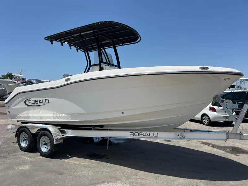 Slide: The Image of 2025 Robalo R200 Center Console boat on trailer, side view, sunny day. - 2