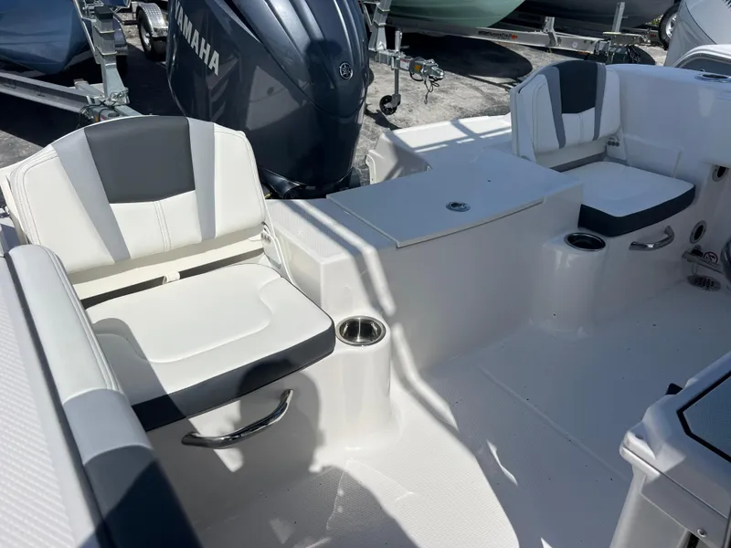 Slide: The Image of 2025 Robalo R200 Center Console boat interior with seating and Yamaha engine. - 20