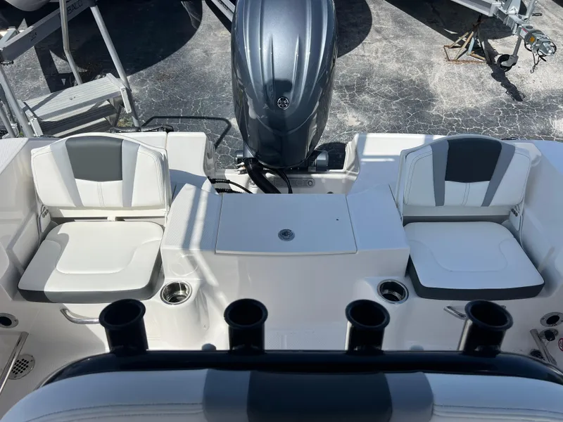 Slide: The Image of 2025 Robalo R200 Center Console boat interior with seating and engine view. - 21