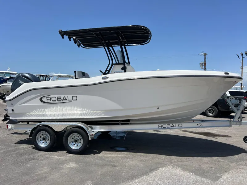 Slide: The Image of 2025 Robalo R200 Center Console boat on trailer, side view, sunny day. - 3