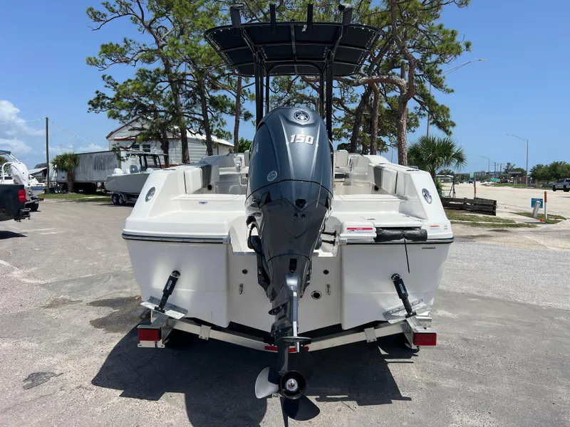 Slide: The Image of 2025 Robalo R200 Center Console boat with Yamaha 130 outboard motor, parked outdoors. - 6