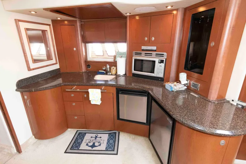 Slide: The Image of Luxurious interior of 2007 Sea Ray 44 Sundancer yacht with modern kitchen and seating area. - 13