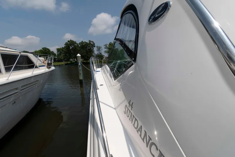 Slide: The Image of Helm of 2007 Sea Ray 44 Sundancer with wooden steering wheel and navigation controls. - 9