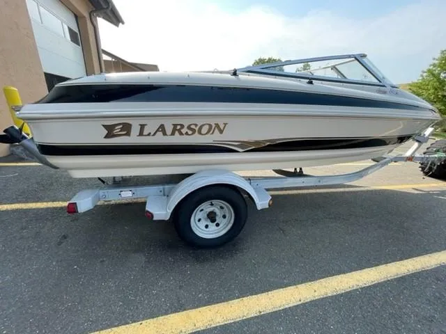 Slide: The Image of 2003 Larson 190LXi boat on trailer, parked outdoors. - 0