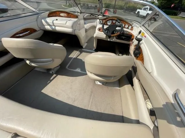 Slide: The Image of Interior of a 2003 Larson 190LXi boat with beige seating and wood accents. - 3