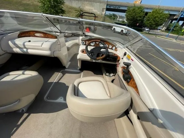 Slide: The Image of 2003 Larson 190LXi boat interior with beige seating and wood accents. - 4