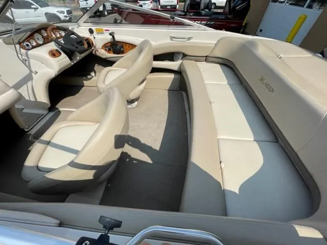 Slide: The Image of 2003 Larson 190LXi boat interior with beige seating and dashboard. - 5