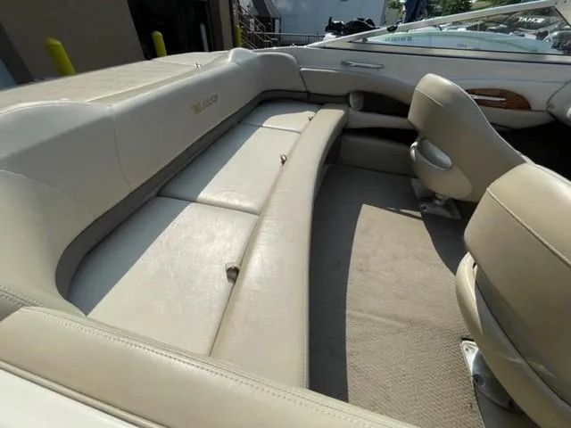 Slide: The Image of 2003 Larson 190LXi boat interior with beige leather seating and carpeted floor. - 6
