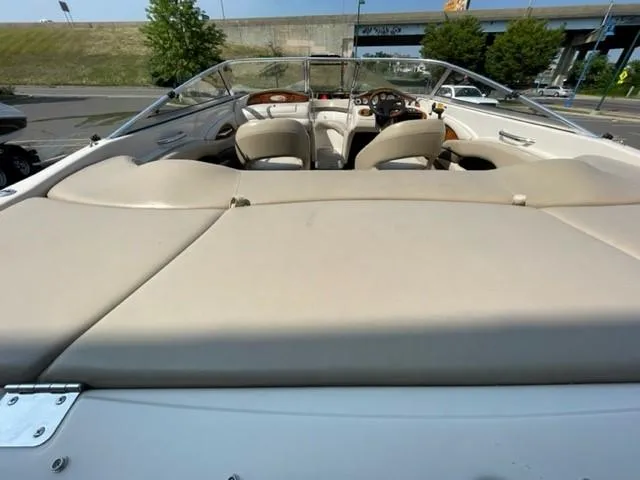 Slide: The Image of 2003 Larson 190LXi boat interior with beige seating and dashboard view. - 7