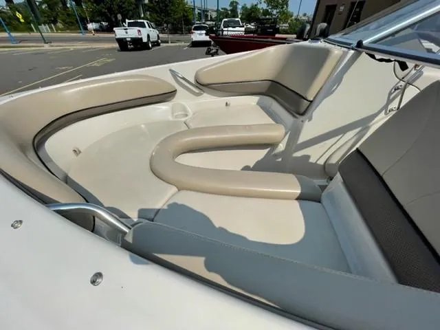 Slide: The Image of 2003 Larson 190LXi boat interior with beige seating and open bow design. - 8