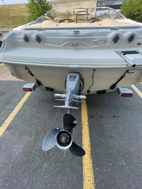 Slide: The Image of 2003 Larson 190LXi boat rear view with outboard motor in parking lot. - 9